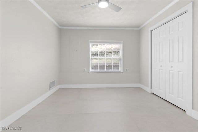 unfurnished bedroom with baseboards, a closet, visible vents, and crown molding