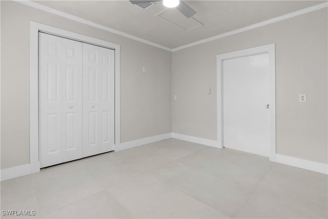 unfurnished bedroom featuring ornamental molding, attic access, and baseboards