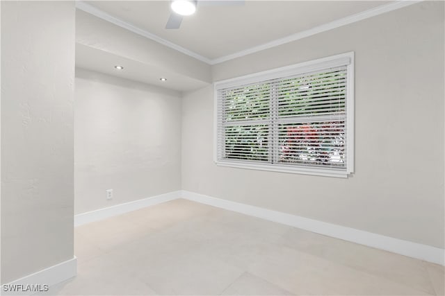 empty room with ceiling fan, baseboards, and crown molding