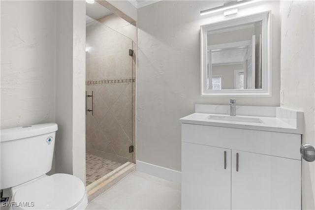 bathroom featuring toilet, a shower stall, vanity, and baseboards