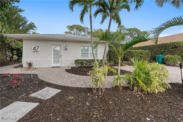 view of front of property with a patio and stucco siding