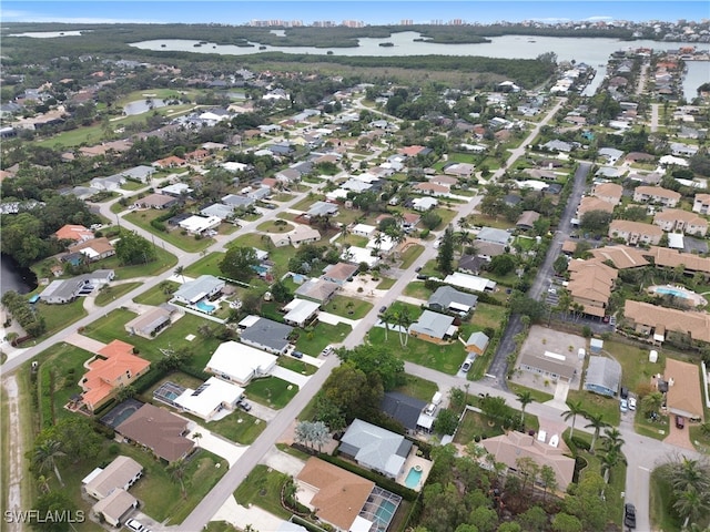 birds eye view of property featuring a water view and a residential view