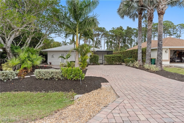 view of front of home featuring decorative driveway and stucco siding