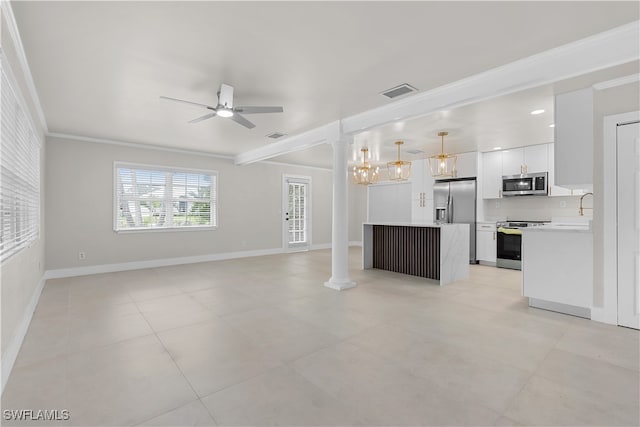 unfurnished living room featuring ornate columns, visible vents, a ceiling fan, ornamental molding, and baseboards