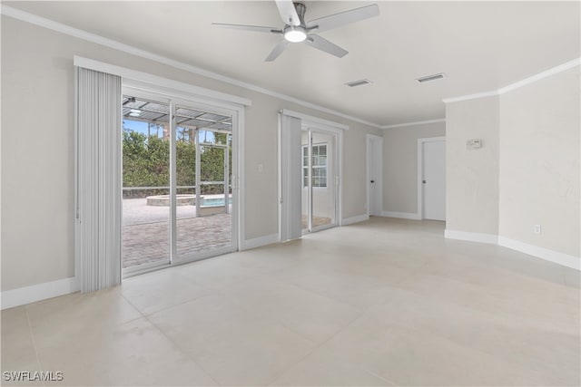 empty room featuring a ceiling fan, baseboards, visible vents, and crown molding