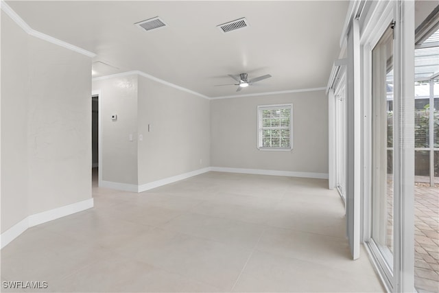 empty room with baseboards, ceiling fan, visible vents, and crown molding