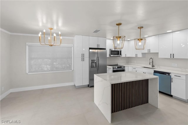 kitchen with appliances with stainless steel finishes, a sink, visible vents, and white cabinetry