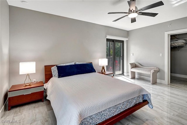 bedroom featuring a spacious closet, access to exterior, and ceiling fan