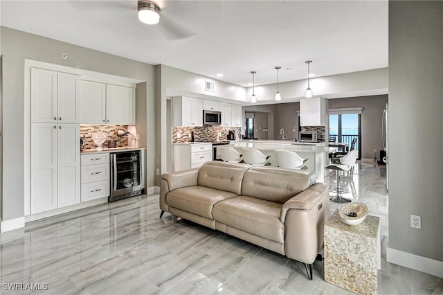 living room featuring beverage cooler and ceiling fan