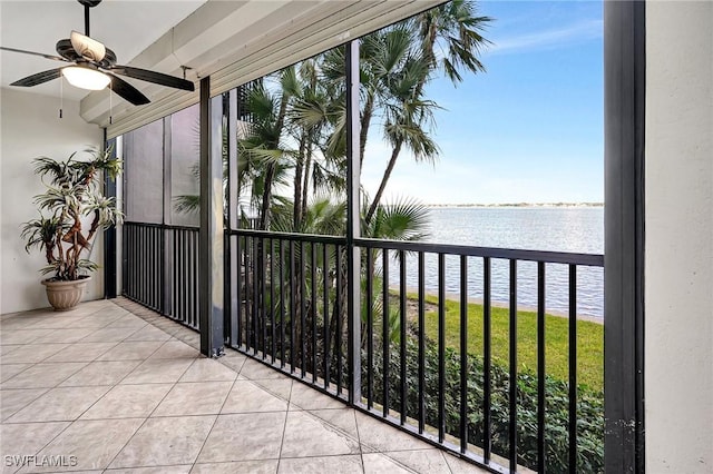 balcony with a water view and ceiling fan