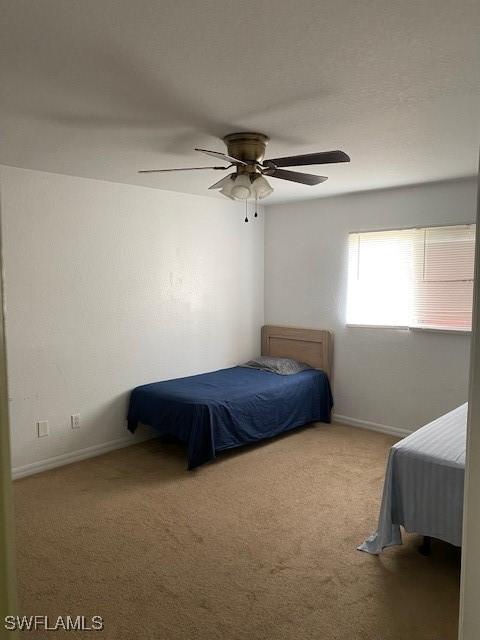 unfurnished bedroom featuring ceiling fan and carpet flooring