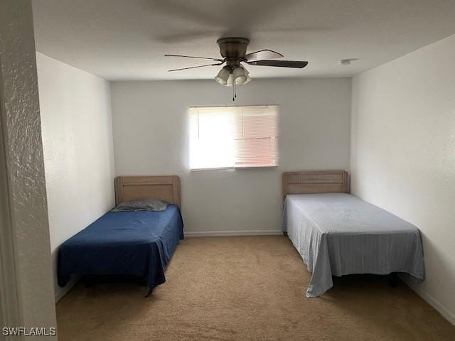 unfurnished bedroom featuring ceiling fan and light colored carpet