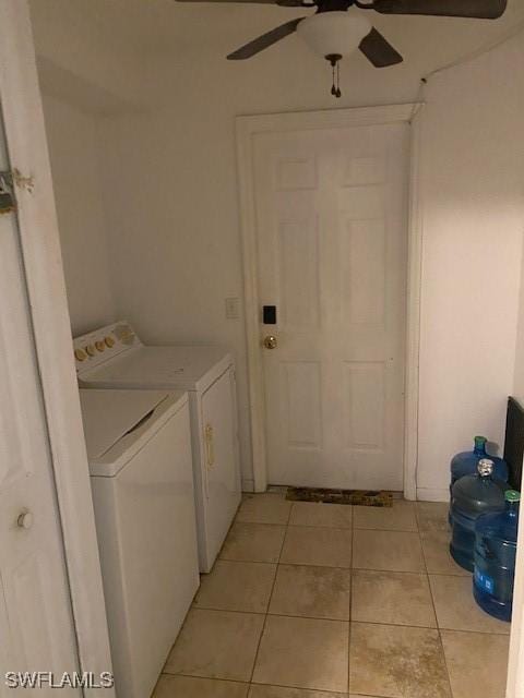 laundry area with ceiling fan, light tile patterned floors, and washer and clothes dryer