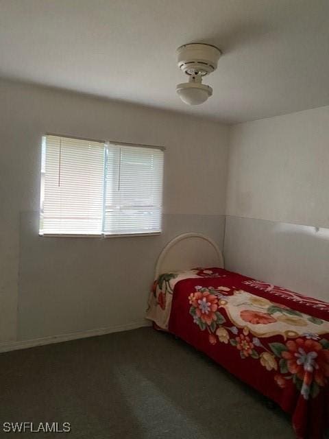 carpeted bedroom featuring multiple windows