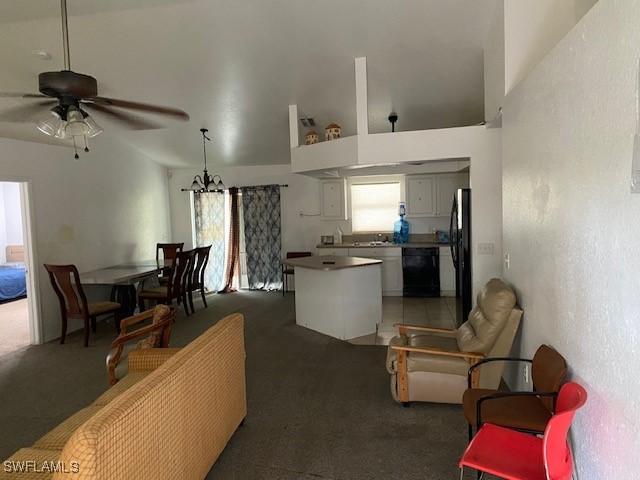 carpeted living room with ceiling fan and a wealth of natural light