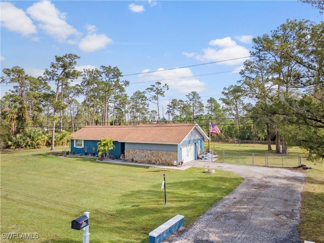 view of front of home with a front yard and a garage