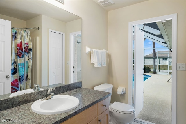 bathroom featuring vanity, toilet, and a shower with shower curtain