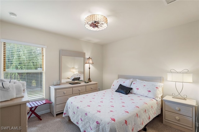 carpeted bedroom featuring multiple windows