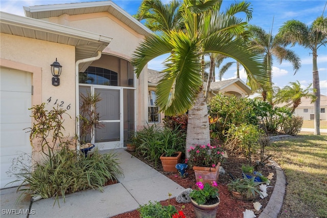 view of exterior entry with a garage