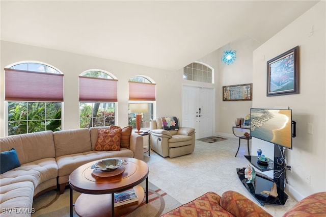 tiled living room featuring vaulted ceiling