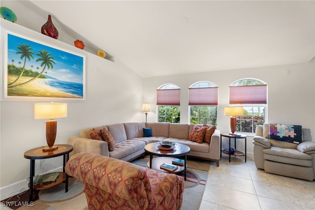 living room featuring lofted ceiling and light tile patterned floors