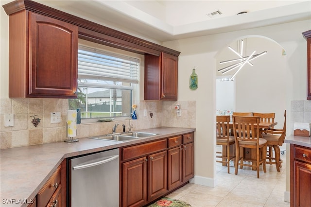 kitchen with sink, light tile patterned floors, stainless steel dishwasher, and backsplash