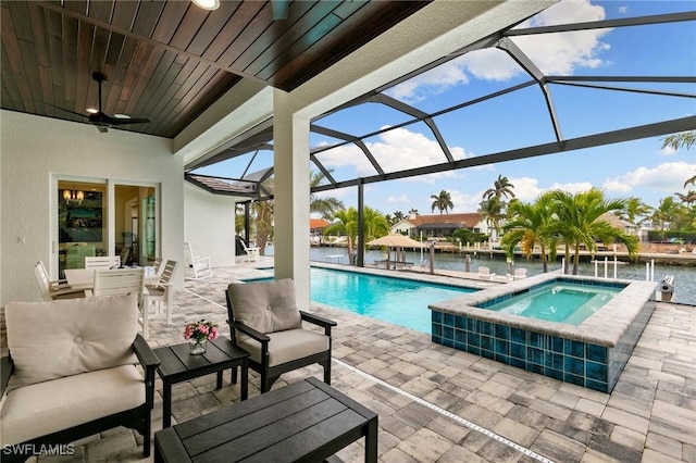 view of swimming pool with glass enclosure, an in ground hot tub, a patio, and an outdoor living space