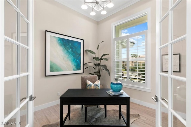 home office featuring light wood-type flooring, french doors, a chandelier, and crown molding