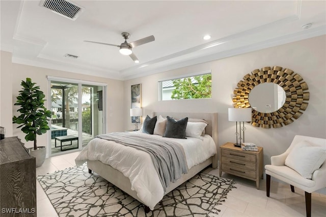 tiled bedroom featuring ceiling fan, multiple windows, a raised ceiling, and access to outside