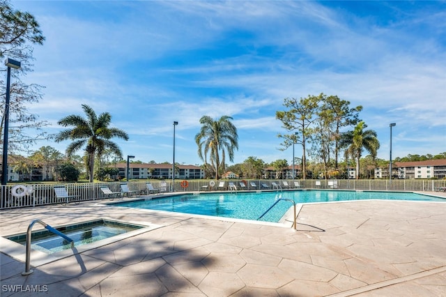 view of swimming pool with a patio area and a community hot tub