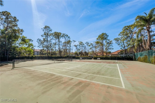 view of tennis court featuring basketball hoop