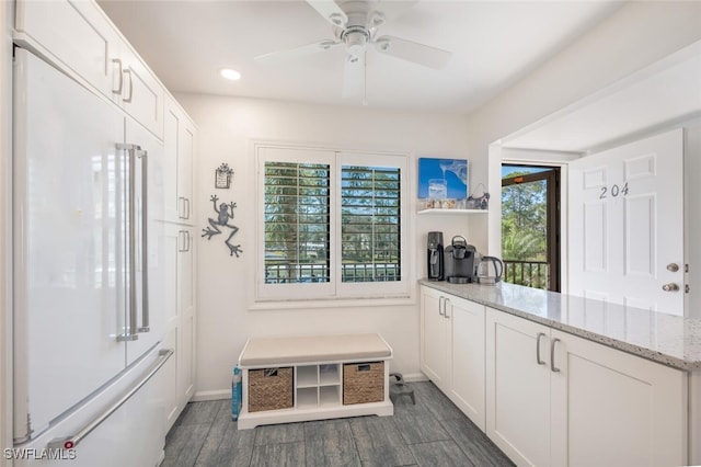 kitchen featuring white cabinetry, light stone countertops, white fridge, and ceiling fan