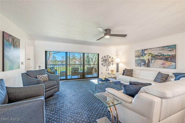 carpeted living room featuring a textured ceiling and ceiling fan