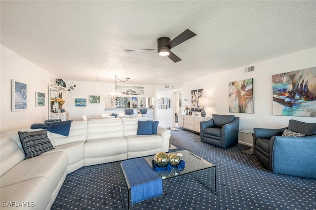 carpeted living room featuring ceiling fan and a textured ceiling