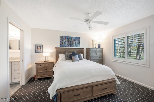 carpeted bedroom featuring ceiling fan, a textured ceiling, and ensuite bath