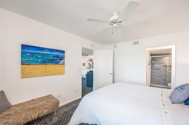 bedroom with ceiling fan, carpet floors, and a textured ceiling