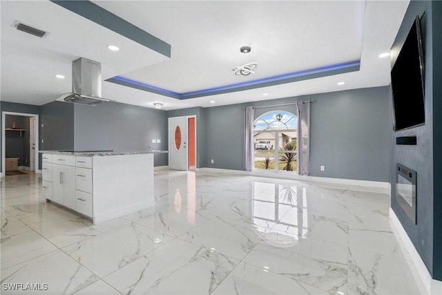 interior space featuring a fireplace and a tray ceiling