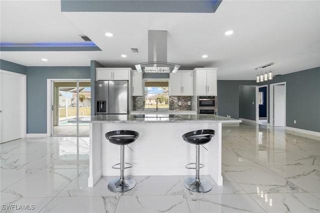 kitchen with white cabinetry, stainless steel fridge, tasteful backsplash, and island exhaust hood