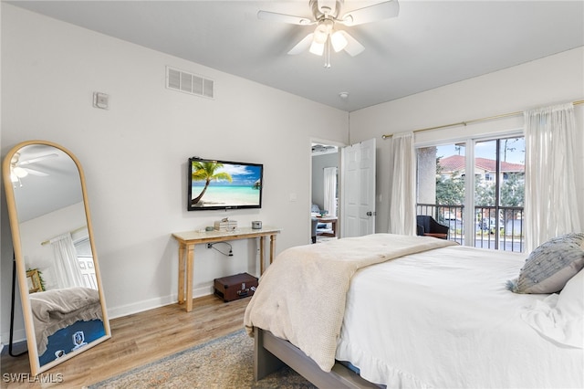 bedroom with hardwood / wood-style flooring, access to outside, and ceiling fan