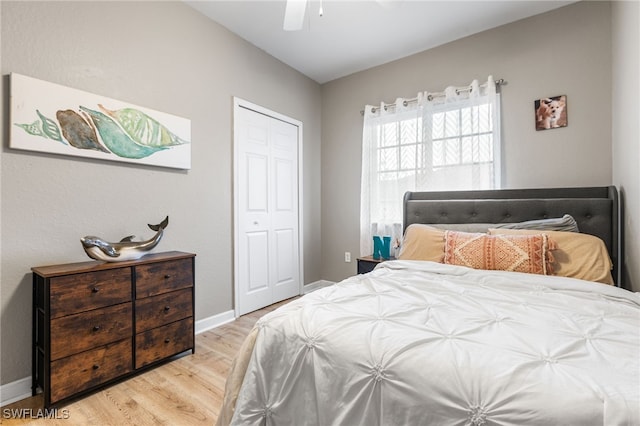 bedroom featuring light hardwood / wood-style flooring, a closet, and ceiling fan