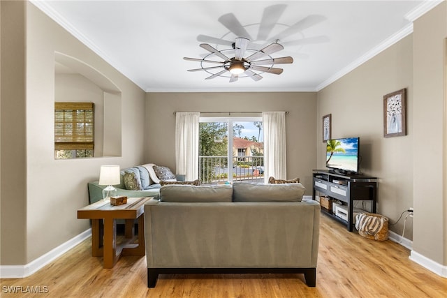 living area featuring a ceiling fan, light wood finished floors, ornamental molding, and baseboards
