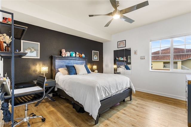 bedroom with ceiling fan and light hardwood / wood-style floors