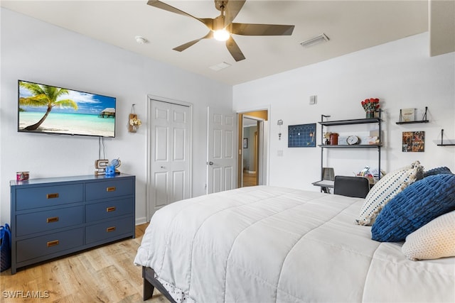 bedroom featuring ceiling fan, light hardwood / wood-style floors, and a closet