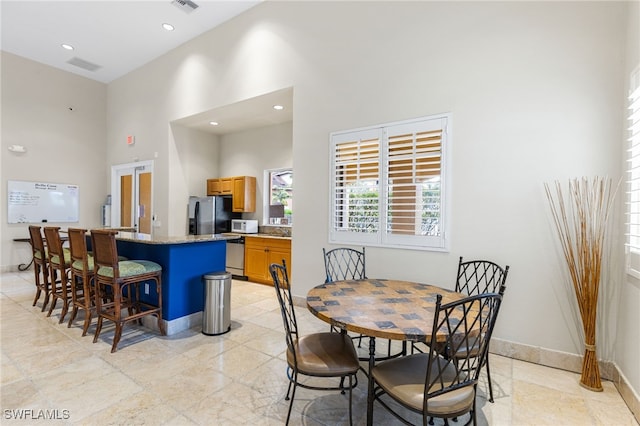 dining room with a high ceiling