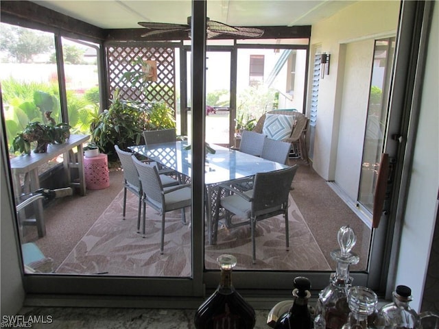 sunroom featuring ceiling fan