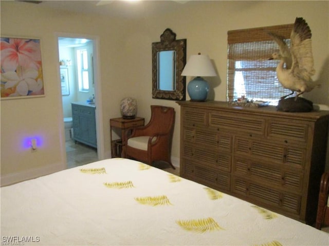 bedroom featuring multiple windows and ensuite bath