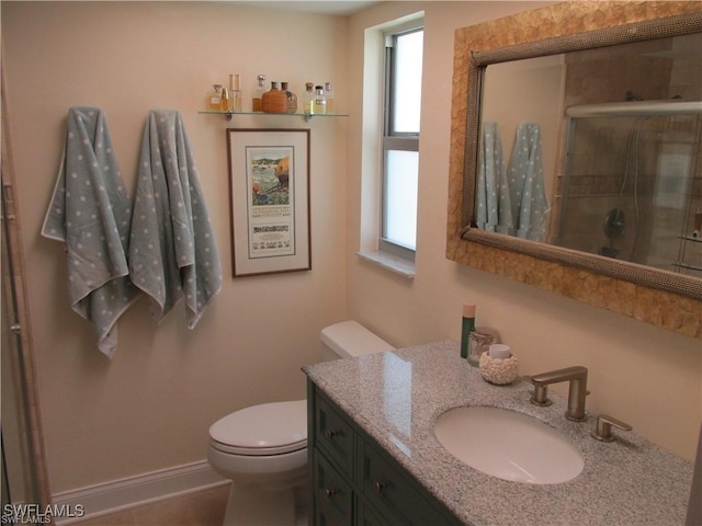 bathroom featuring vanity, toilet, and an enclosed shower