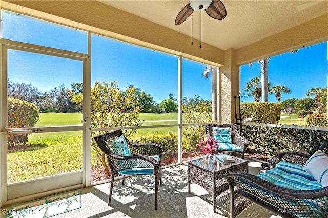 sunroom featuring a ceiling fan