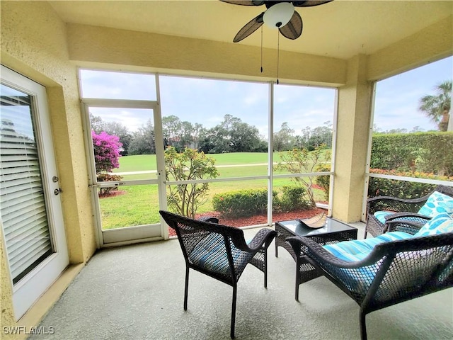 sunroom featuring a ceiling fan