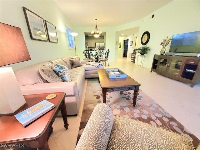 living room featuring tile patterned floors and a notable chandelier